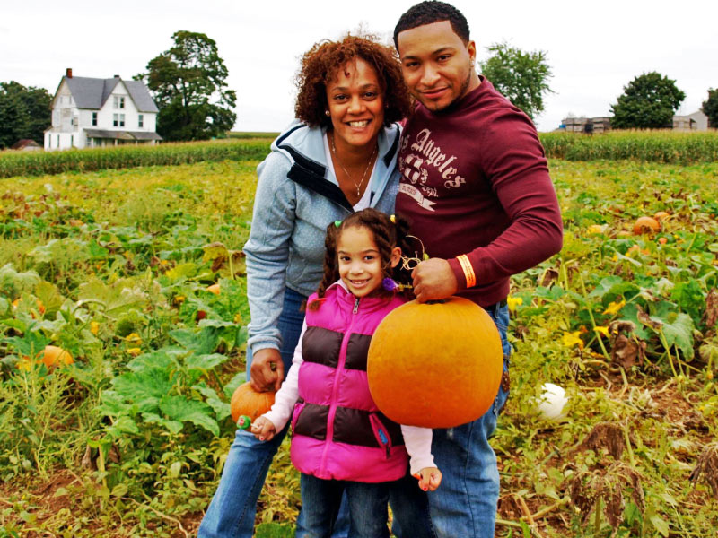 Family picking pumpkins