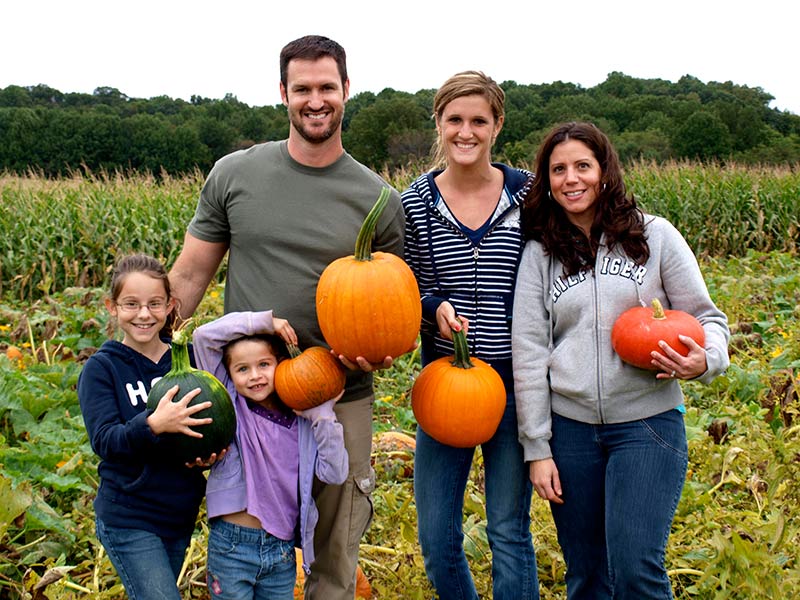 Pumpkin picking family in the pumpkin patch