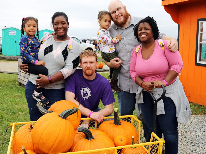 Family with cart full of u-pick pumpkins